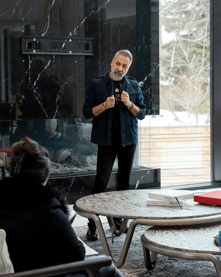 Peter Torkan standing and speaking to a small group of agents seated in a bright living room